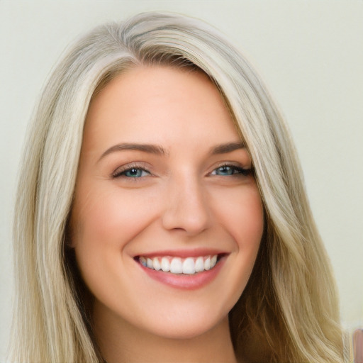 Joyful white young-adult female with long  brown hair and blue eyes