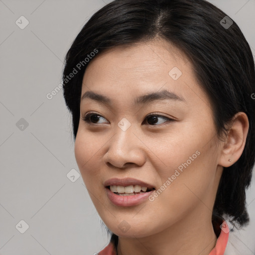 Joyful asian young-adult female with long  black hair and brown eyes