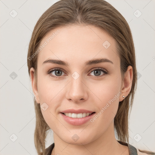 Joyful white young-adult female with medium  brown hair and grey eyes