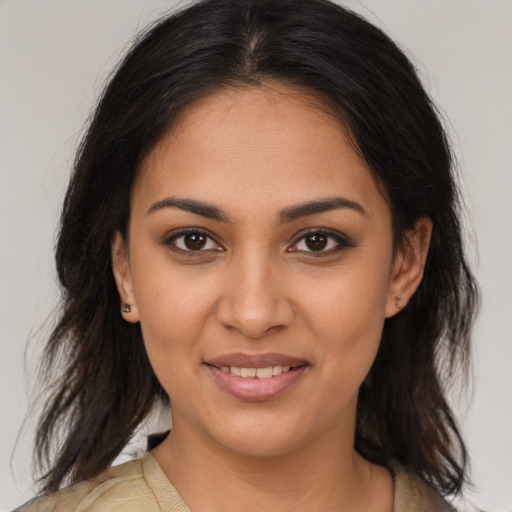 Joyful latino young-adult female with medium  brown hair and brown eyes