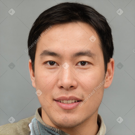 Joyful asian adult male with short  brown hair and brown eyes