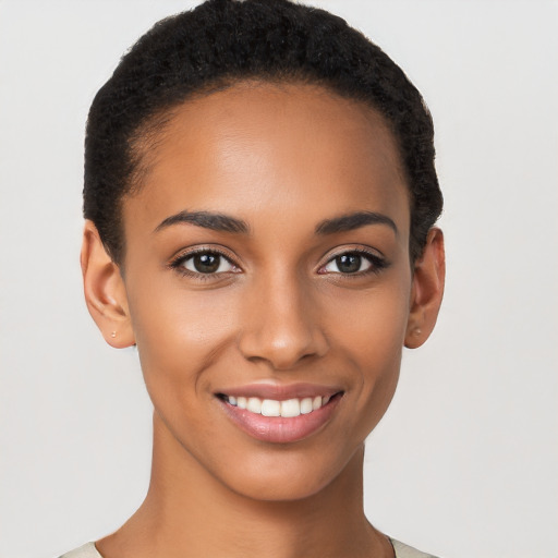 Joyful latino young-adult female with short  black hair and brown eyes