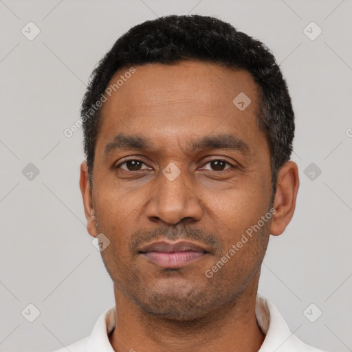 Neutral latino adult male with short  black hair and brown eyes
