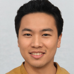 Joyful asian young-adult male with short  brown hair and brown eyes