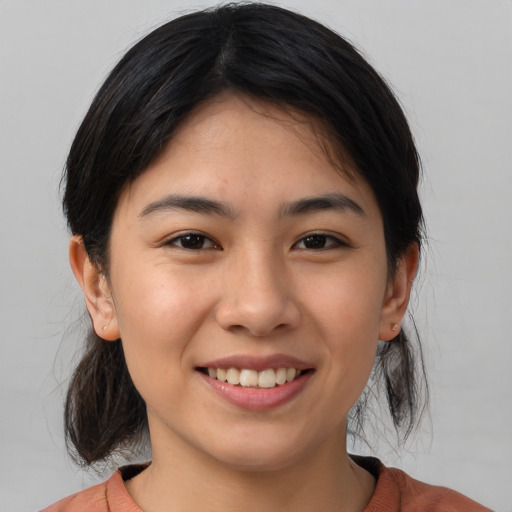 Joyful asian young-adult female with medium  brown hair and brown eyes