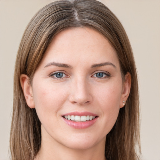 Joyful white young-adult female with long  brown hair and grey eyes