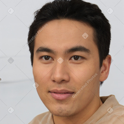 Joyful white young-adult male with short  black hair and brown eyes