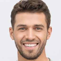 Joyful white young-adult male with short  brown hair and brown eyes