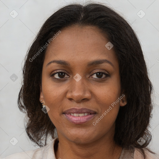 Joyful black young-adult female with long  brown hair and brown eyes