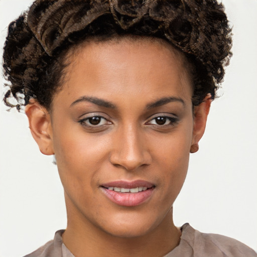 Joyful black young-adult female with short  brown hair and brown eyes