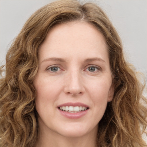 Joyful white young-adult female with long  brown hair and green eyes