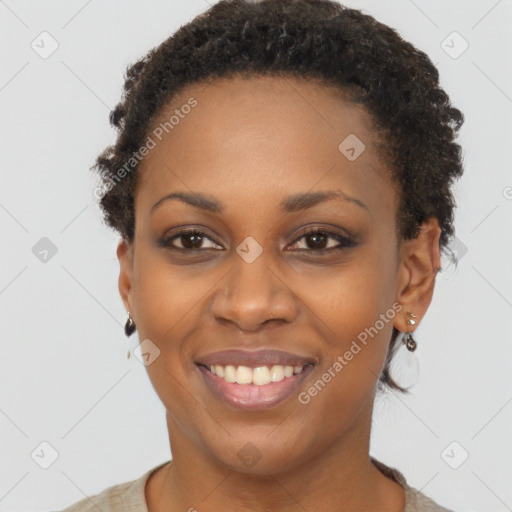 Joyful black young-adult female with short  brown hair and brown eyes