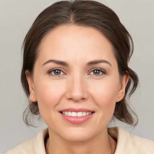 Joyful white young-adult female with medium  brown hair and brown eyes