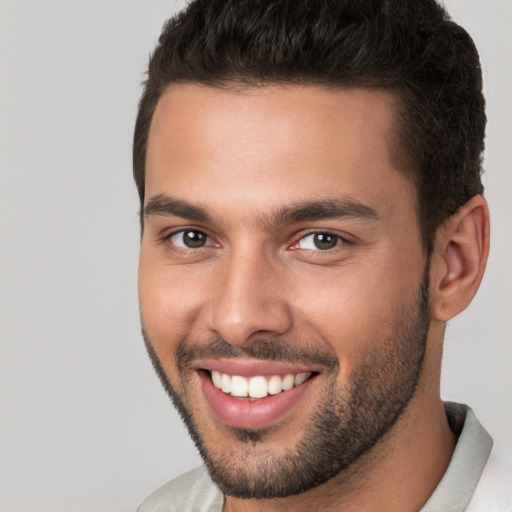 Joyful white young-adult male with short  brown hair and brown eyes