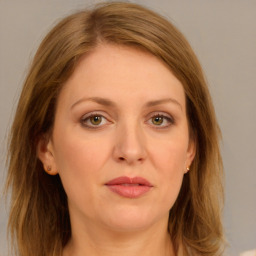 Joyful white young-adult female with long  brown hair and green eyes