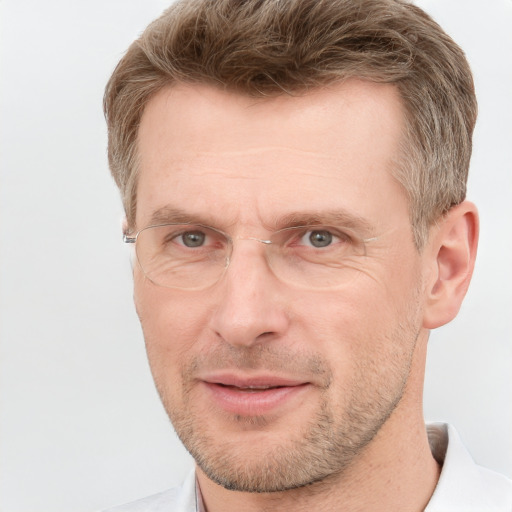 Joyful white adult male with short  brown hair and grey eyes