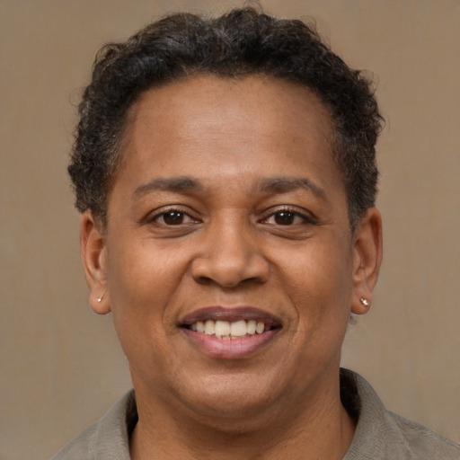Joyful latino adult female with short  brown hair and brown eyes