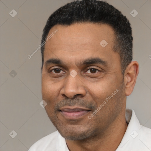 Joyful latino adult male with short  black hair and brown eyes