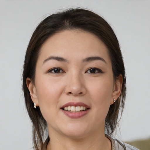 Joyful white young-adult female with medium  brown hair and brown eyes