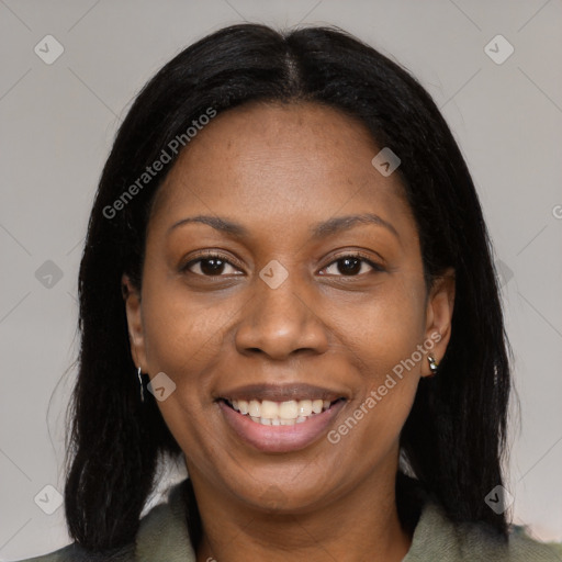 Joyful black young-adult female with long  brown hair and brown eyes