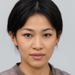 Joyful asian young-adult female with medium  brown hair and brown eyes