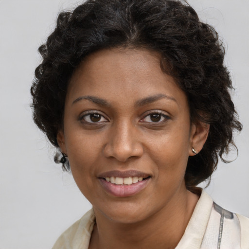 Joyful black young-adult female with medium  brown hair and brown eyes
