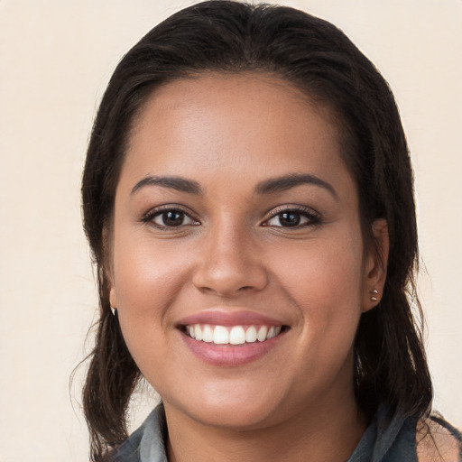 Joyful white young-adult female with long  brown hair and brown eyes