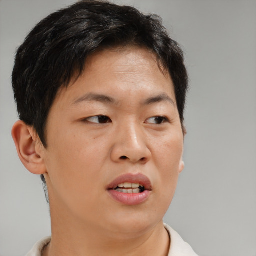 Joyful asian young-adult female with short  brown hair and brown eyes