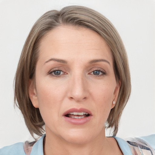 Joyful white adult female with medium  brown hair and grey eyes