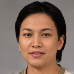 Joyful asian adult female with medium  brown hair and brown eyes