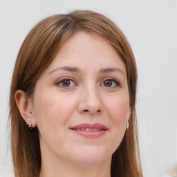 Joyful white adult female with long  brown hair and grey eyes