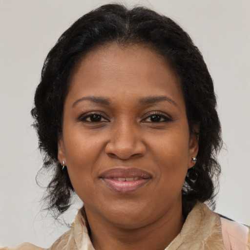 Joyful black adult female with medium  brown hair and brown eyes