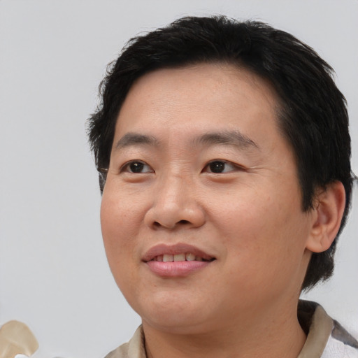 Joyful white young-adult male with short  black hair and brown eyes