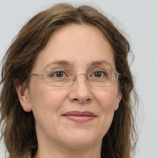 Joyful white adult female with long  brown hair and grey eyes