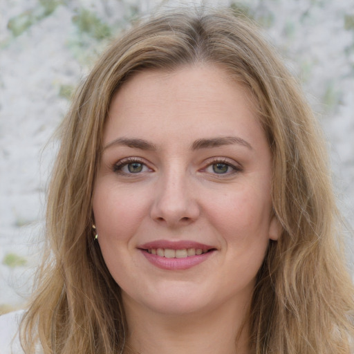 Joyful white young-adult female with long  brown hair and green eyes