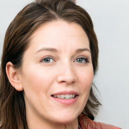 Joyful white young-adult female with long  brown hair and blue eyes