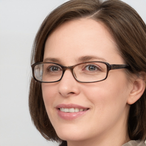 Joyful white adult female with medium  brown hair and grey eyes