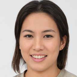 Joyful asian young-adult female with medium  brown hair and brown eyes