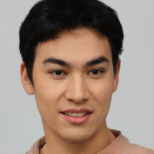 Joyful asian young-adult male with short  black hair and brown eyes