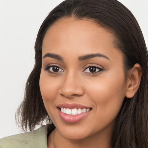 Joyful latino young-adult female with long  brown hair and brown eyes