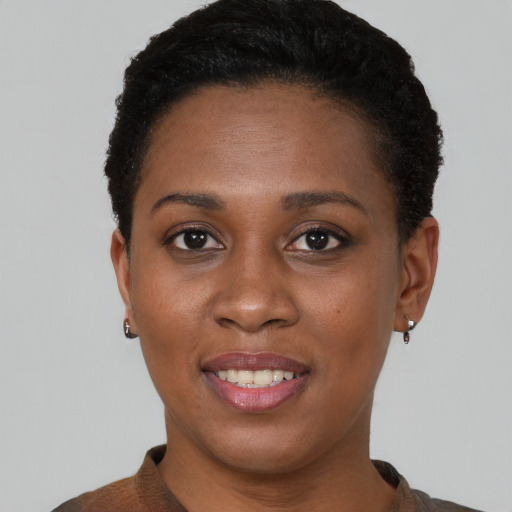 Joyful black young-adult female with short  brown hair and brown eyes