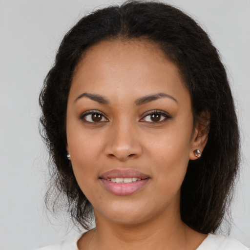 Joyful latino young-adult female with long  brown hair and brown eyes