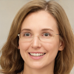 Joyful white adult female with long  brown hair and green eyes