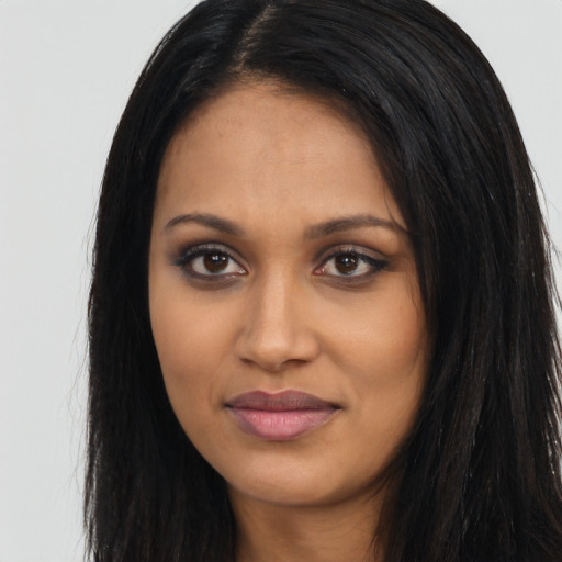 Joyful latino young-adult female with long  black hair and brown eyes