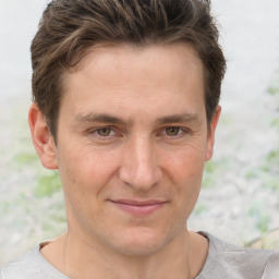 Joyful white adult male with short  brown hair and brown eyes