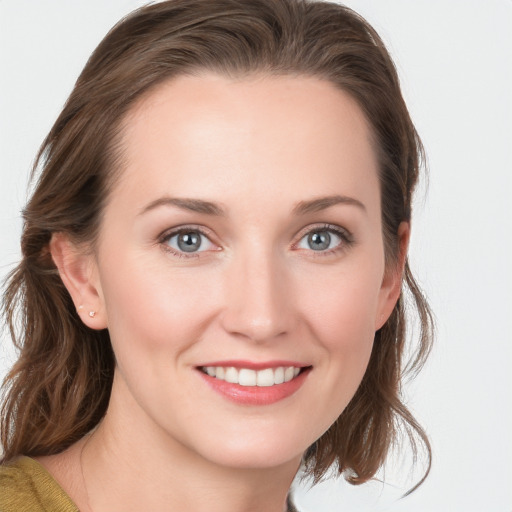 Joyful white young-adult female with medium  brown hair and blue eyes