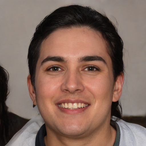 Joyful white young-adult male with medium  brown hair and brown eyes