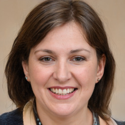 Joyful white adult female with medium  brown hair and brown eyes