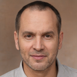 Joyful white adult male with short  brown hair and brown eyes