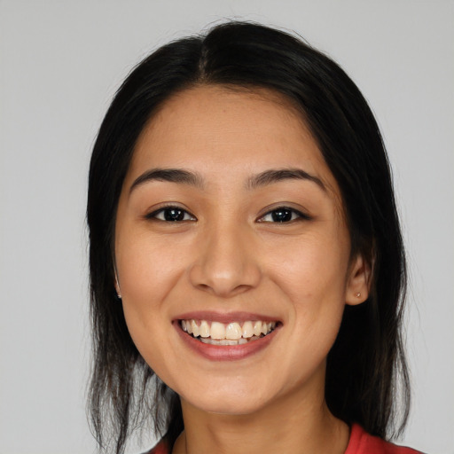 Joyful white young-adult female with long  brown hair and brown eyes